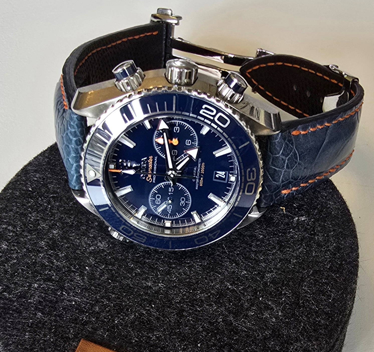 Omega Planet Ocean Chronograph on Azure Blue Ostrich Leg - At Dangerous9straps, we’re always excited to see how our clients pair their custom straps with beloved timepieces—and this week’s Watch of the Week is no exception. Alex’s Omega Seamaster Planet Ocean 600M Co‑Axial Master Chronometer Chronograph is a bold, blue beast of a dive watch, and he’s paired it beautifully with our newly arrived Azure Blue Ostrich Leg skin strap with orange stitching.